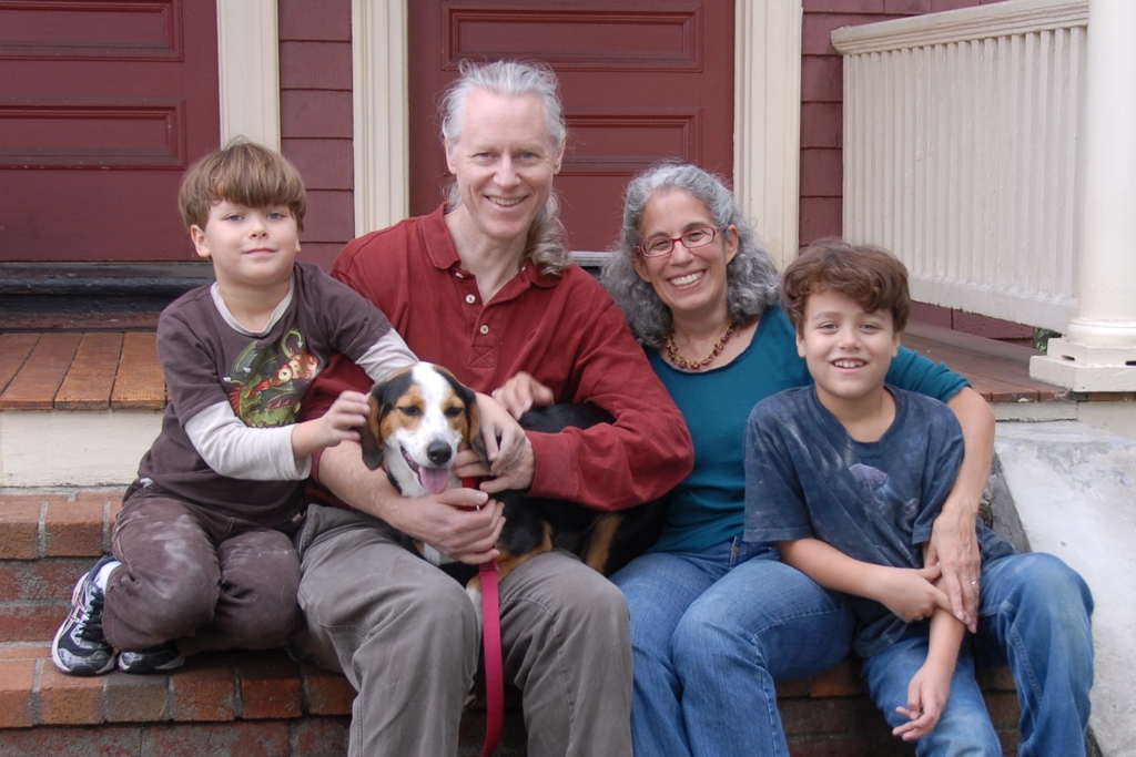 Sparkle with her adoptive family, sitting on the porch